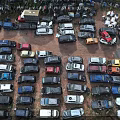 Parking Lot With Many Cars Of Different Colors And Models Parked Closely