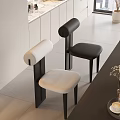Modern Dining Chairs In Open Kitchen With White Upholstered Seats Black Frames And Marble Countertop