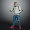 A man wearing hoodie and jeans using phone with backpack on gray background