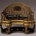 Ornate Single Chair With Intricate Gold Carvings And Dark Panel Design