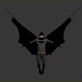 Man in Batman Costume with Large Wings Standing on Gray Background