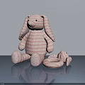Pink Striped Stuffed Rabbit Toy With Long Ears And Small Companion On Reflective Gray Surface