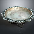 Elegant Silver Decorative Plate With Intricate Edge Patterns And Carved Stand Base