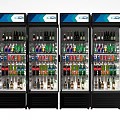 Four Commercial Beverage Refrigerators With Glass Doors And Assorted Bottled Drinks