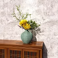 Green Ceramic Vase With Yellow Flowers And Green Branches On Wooden Cabinet Against Gray Wall