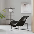 Modern Black Leather Lounge Chair With Metal Frame Artwork And Green Plant In Stylish Interior