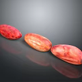Three Red Brown Oval Cocoa Beans Arranged On Black Surface With Reflections 3d model