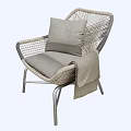 Stylish Rattan Leisure Chair With Metal Legs Gray Cushion Pillow And Draped Blanket