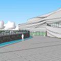 Modern Curved Roof Building Exterior With Landscaping Trees And Water Area