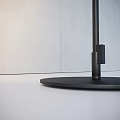 Modern Outdoor Light Featuring Black Slender Cylindrical Lamp Post And Round Base On White Ground