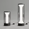 Modern Two Different Sizes Transparent Cylindrical Table Lamps With Black Base And Illuminated Glass Shade