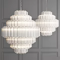 Two Elegant Modern Crystal Chandeliers With Multi Layer Design Hanging On Gray Wall