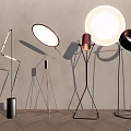 Modern Floor Lamps With Various Geometric Stands And Illuminated Shades On Minimalist Background