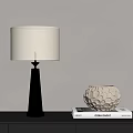 Silver Cone Base Table Lamp with White Fabric Shade and Textured Vase on Books