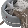 Gray Rocking Baby Crib With Metal Frame Wooden Rockers Star Patterned Pillows And Striped Blanket
