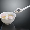 Traditional Chinese Tangyuan in White Bowl with Soup Pink White and Black Balls and Spoon