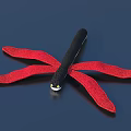 Colorful Dragonfly Doll With Black Body And Red Wings On Dark Background