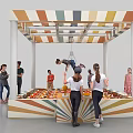 Vibrant Colorful Striped Pavilion With Fruit Stand And People Interacting
