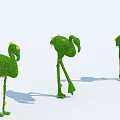 Three Flamingo Shaped Topiary Shrubs With Yellow Flowers In Different Poses