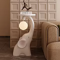 White Elephant Decorative Ornament Combination With Tabletop Light Next To Beige Sofa On Square Wall