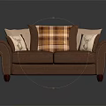 Classic Brown Leather Two Seater Sofa With Plaid And Beige Patterned Cushions And Curved Arms