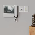 Modern Wall Mounted Doorbell with Screen Displaying Breathe Text Near Light Switches and Decorative Figurine