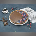 Fresh Chocolate Tart Topped With Blueberries Raspberries And Chocolate Pieces With Coffee Knife And Napkin
