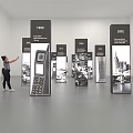 Person Pointing At Display Boards With Years And Images In Exhibition Hall