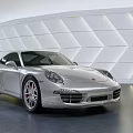 Silver Porsche Sports Car in Modern Indoor Setting with Geometric Patterned Wall and Sleek Design