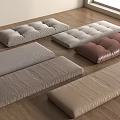 Assorted Floor Cushions In Neutral Tones With Fabric And Leather Textures On Wooden Floor