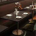 Elegant Black Dining Table Set With Green Chairs Plates Flower Vase And Wine Bottles