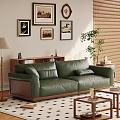 Green Leather Two Seater Sofa with Framed Artworks Floor Lamp Potted Plant and Coffee Table