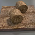 Two Round Hay Bales Placed On Square Wooden Base With Dry Straw