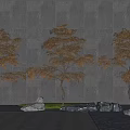 Three Trees with Orange Brown Leaves Against Gray Wall Stone Pavement and Rocks