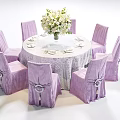 Banquet Hall Setup With Round Dining Table White Tablecloth Purple Chairs And Flower Bouquet