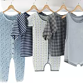 Baby Clothes Hanging On Rack By Wooden Shelf With Decor