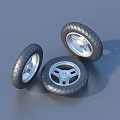 Three Motorcycle Tires With Silver Spoke Rims And Tread Pattern On Gray Surface 3d model