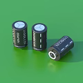 Three Black Cylindrical TANCON 680mAh Household Batteries On Green Surface