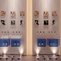 Vertical Striped Background Wall with Portrait Paintings on Shelves and Blue Cabinet Carts with Lighting