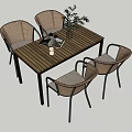 Wooden Outdoor Table with Four Rattan Chairs and a Book with Plant Vase on Top