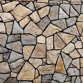 Rustic Building Exterior Wall Featuring Natural Irregular Stone Blocks with Brown Gray Hues and Texture
