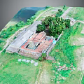 Aerial View of Ancient Architecture with Red Roof Surrounded by Green Grass and Trees