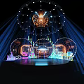 Illuminated Stage Design With Circular Structure Blue Light Beams And Colorful Decorations