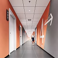 Modern Elevator Hallway With Orange Walls White Doors And Signage