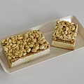 Delicious Layered Dessert with Crunchy Peanut Topping on Beige Tray