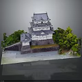 Traditional Japanese Castle with Multi Level Structure Gray Roof White Walls Surrounded By Trees Water