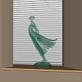 Green Glass Female Figurine With Flowing Dress For Decorative Display On Windowsill With Blinds Background