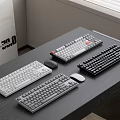 Various Colored Computer Keyboards And Mice On Desktop Office Table