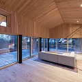 Modern Detached House With Wooden Exterior Black Roof Large Windows And Natural Surroundings