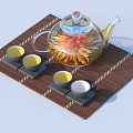 Transparent Glass Teapot With Chrysanthemum And Four Tea Cups On Bamboo Mat Set